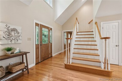 Entrance foyer featuring a high ceiling, light har