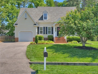 New england style home with a garage and a front l