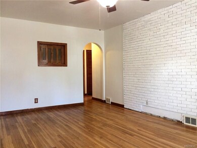 Original hardwood floors, molding, doors, archway,