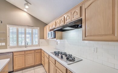 Kitchen featuring light brown cabinets, stainless