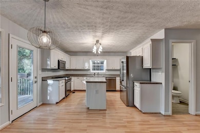 Kitchen with a chandelier, stainless steel applian