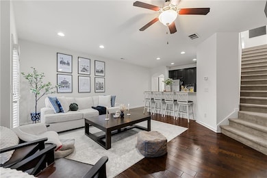 Living area featuring arched walkways, stairs, har