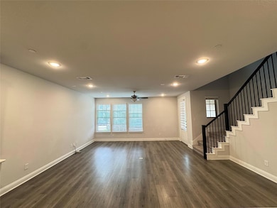 Unfurnished living room with stairs, visible vents