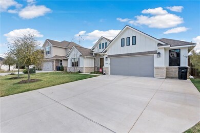 View of front of house with a garage and a front y