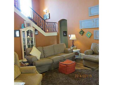 Another view of den. Wrought iron railing up to two bedrooms and full bath.