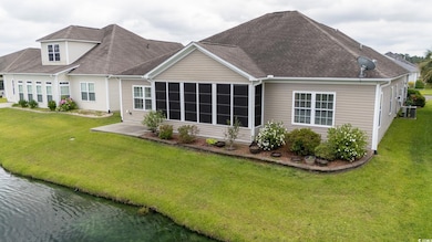 Back of house with roof with shingles, a yard, a sunroom, and central air condition unit