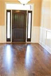 Three panel door and spacious foyer featuring wain