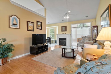 Living room featuring ornamental molding, light wo