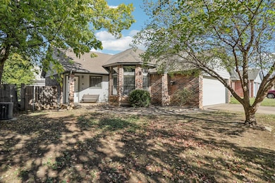 View of front facade with a patio area, a garage, a shingled roof, driveway, and stone siding