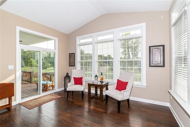 Sun Room~surrounded with windows flooding with natural light and looking out to the covered back deck.