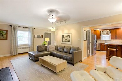Living room open to renovated kitchen area.