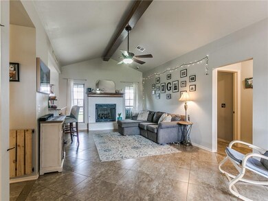The living room features a beamed vaulted ceiling 