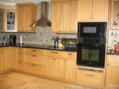 Kitchen - A decorative tile backsplash complements