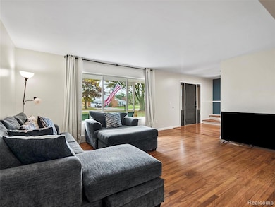 Living area featuring wood finished floors and stairway