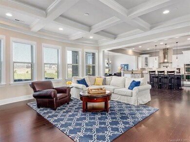 Great room offers a beautiful coffered ceiling, he