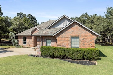 View of front of home featuring a front yard, brick siding, and driveway