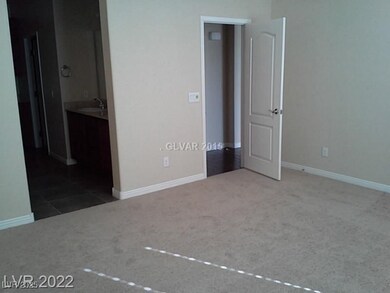 Unfurnished bedroom featuring light carpet and ensuite bath