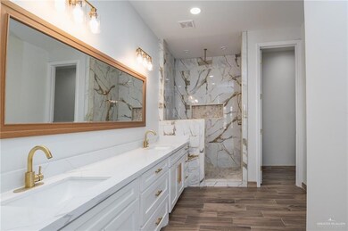 Bathroom with a tile shower and vanity