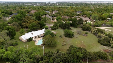 Aerial view featuring a view of trees