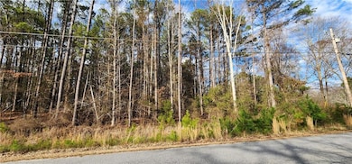 View of asphalt road with street lights