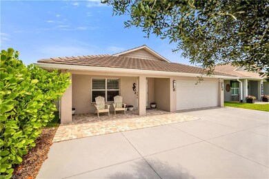 Ranch-style home with stucco siding, a garage, concrete driveway, and a tile roof