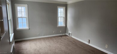 Carpeted empty room with ornamental molding