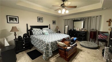 Bedroom featuring a tray ceiling, carpet flooring,