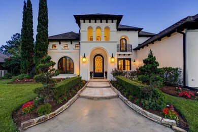 Bold arches and lyrical ironwork reinforce the Mediterranean styling throughout this expansive 6,410 residence. Here, handsome lanterns guide you from the circular driveway to the impressive entryway.