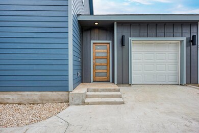 Entrance to property featuring a garage and board