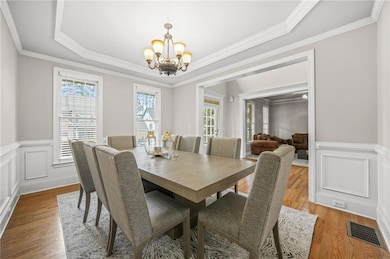 Dining space with visible vents, light wood-style 