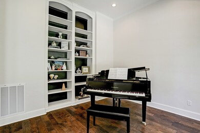 The room features floor to ceiling built in bookshelves.