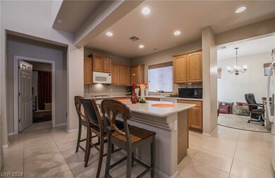 Kitchen features tile flooring, island, breakfast