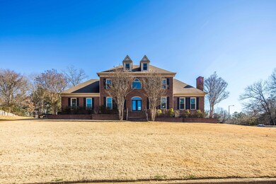 Colonial-style house featuring a front yard