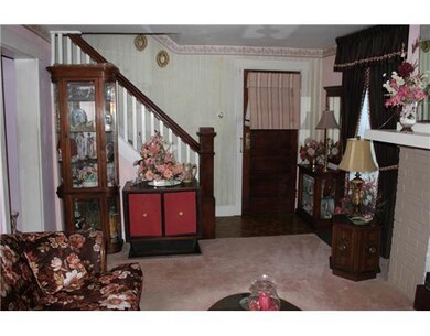 Living Room. Staircase has beautiful woodwork deta