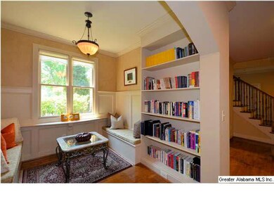 Cozy library is just off foyer and open to greatro