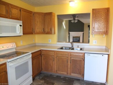 Fully applianced kitchen with opening to great roo