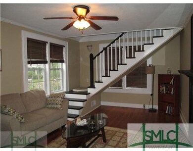 Living Room. Staircase to Second Floor to Laundry 