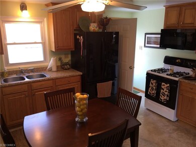 Kitchen view from living room toward back door. Up