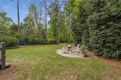 View of back yard with fire pit area seating