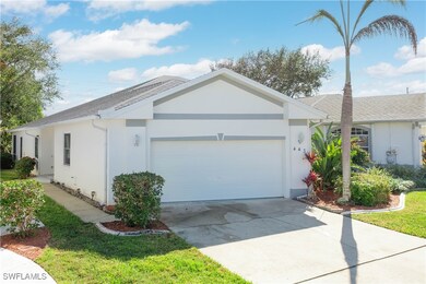 Ranch-style house featuring a garage and a front y
