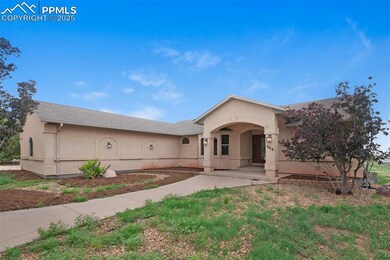 View of front facade with stucco siding and driveway