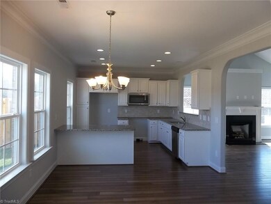 View of kitchen and eating area.  Stainless steel radiant top range does come with this home.