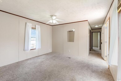 Unfurnished room with light colored carpet, a text
