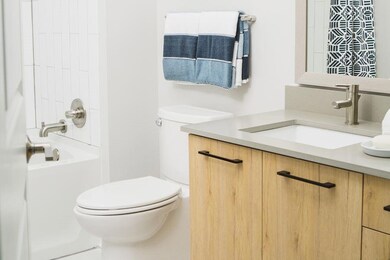 Full bathroom with vanity, toilet, and shower / washtub combination