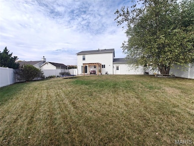 Back of house featuring a trampoline, a fenced backyard, and a patio