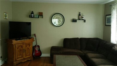 FRESHLY PAINTED LIVING ROOM WITH HARDWOOD FLOORS