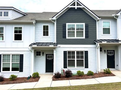 Townhome / multi-family property featuring brick siding