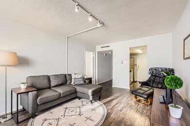 Living area featuring wood finished floors, a tex