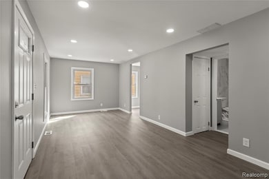 Unfurnished bedroom featuring recessed lighting and dark wood-style flooring
