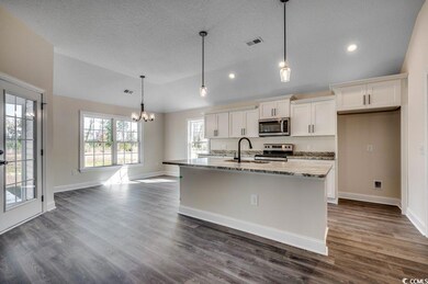 Kitchen featuring light stone countertops, applian